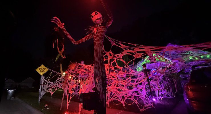 Giant red and purple spider web covering a yard with a tall Jack Skellington figure on Peninsula Cove Drive in Charleston, SC