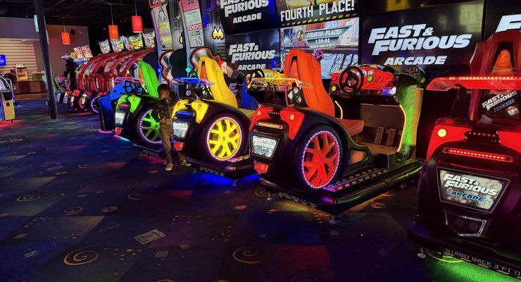 Row of colorful Fast and Furious Arcade racing seats at Stars and Strikes in Summerville, SC
