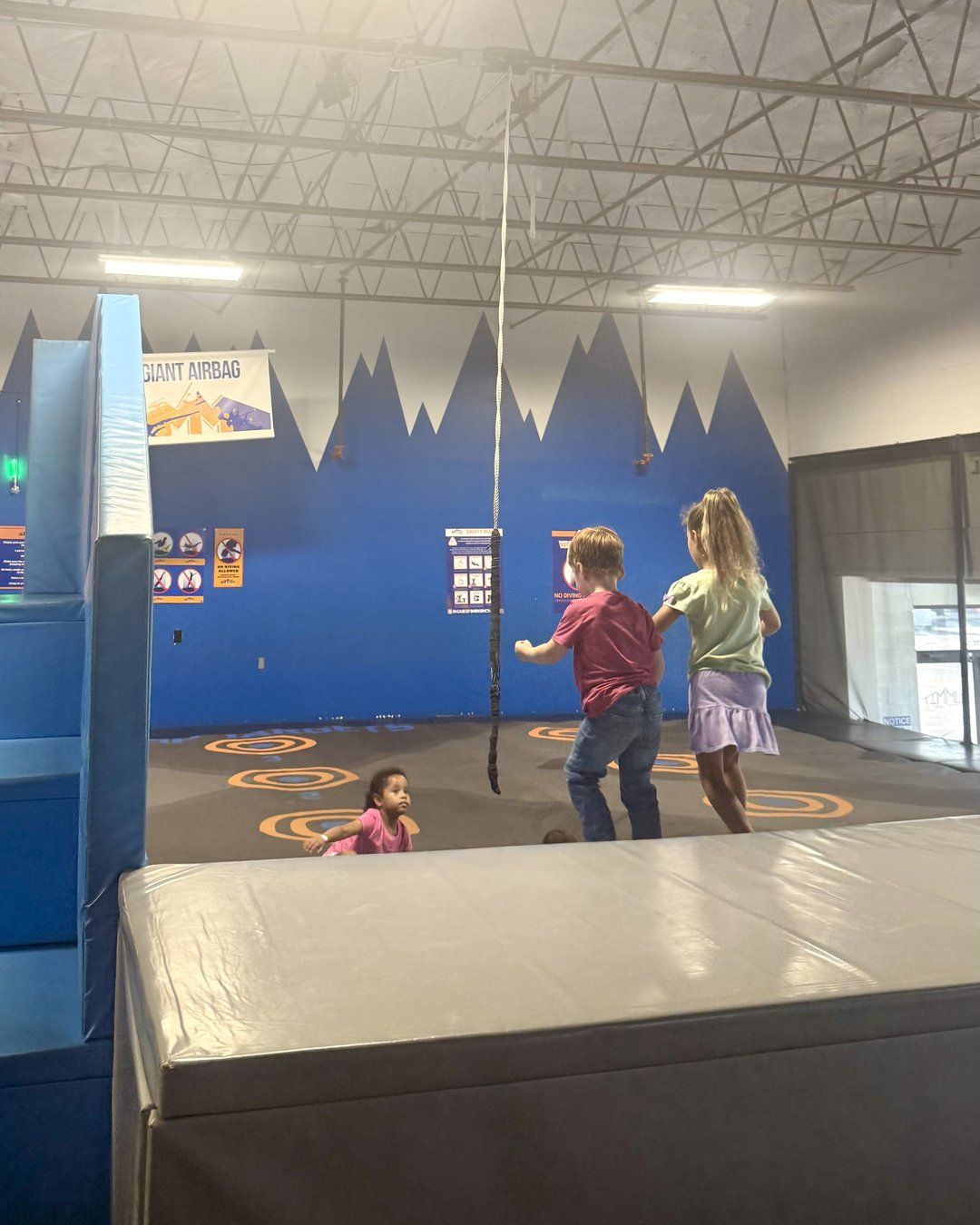 Kids playing near the giant airbag zone at Summit Adventure Park in Charleston